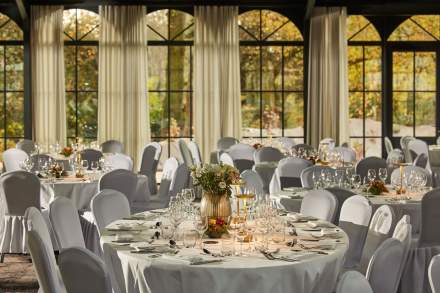 Salle de réception lumineuse du Domaine du Liziec décorée pour un mariage élégant avec vue sur le parc